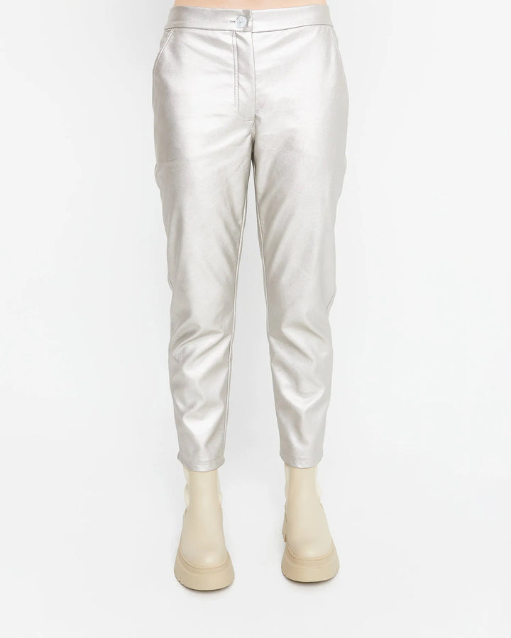 A fashion forward woman wearing a pair of Ozai N Ku Metallic Pants in Gloss.