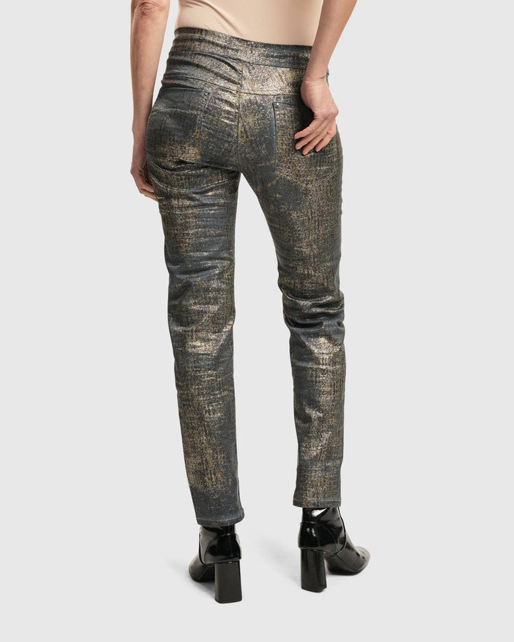 The back view of a woman over 50 wearing ALEMBIKA's Iconic Jeans Desires in Petrol.