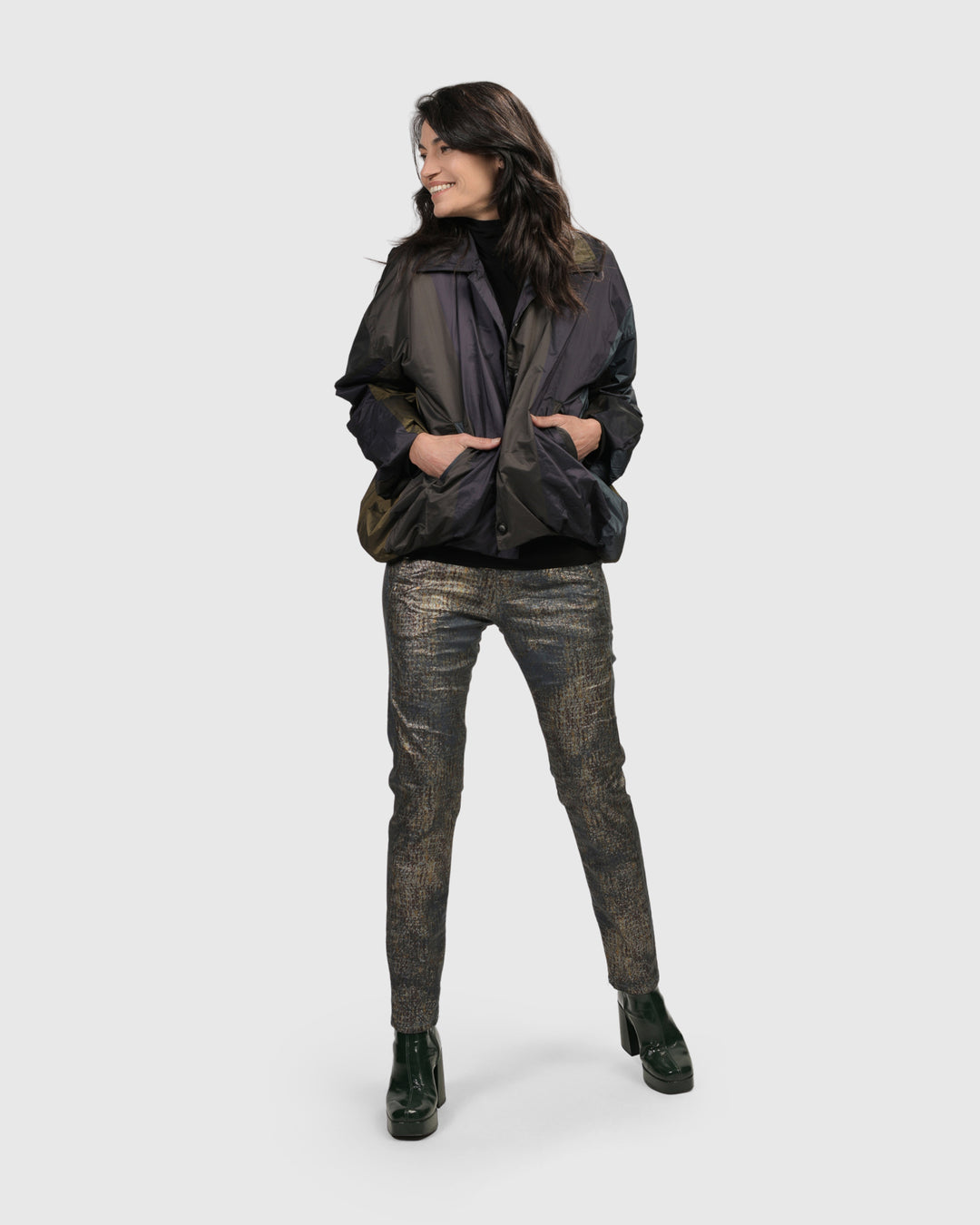 A woman wearing a black jacket and Alembika Iconic Jeans Desires.