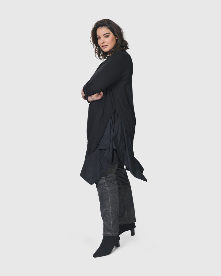 A woman wearing an ALEMBIKA Urban New Wave Tunic Top in Black.