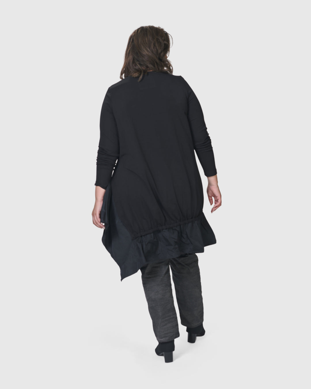 The back of a woman wearing an ALEMBIKA Urban New Wave Tunic Top in Black with long sleeves.